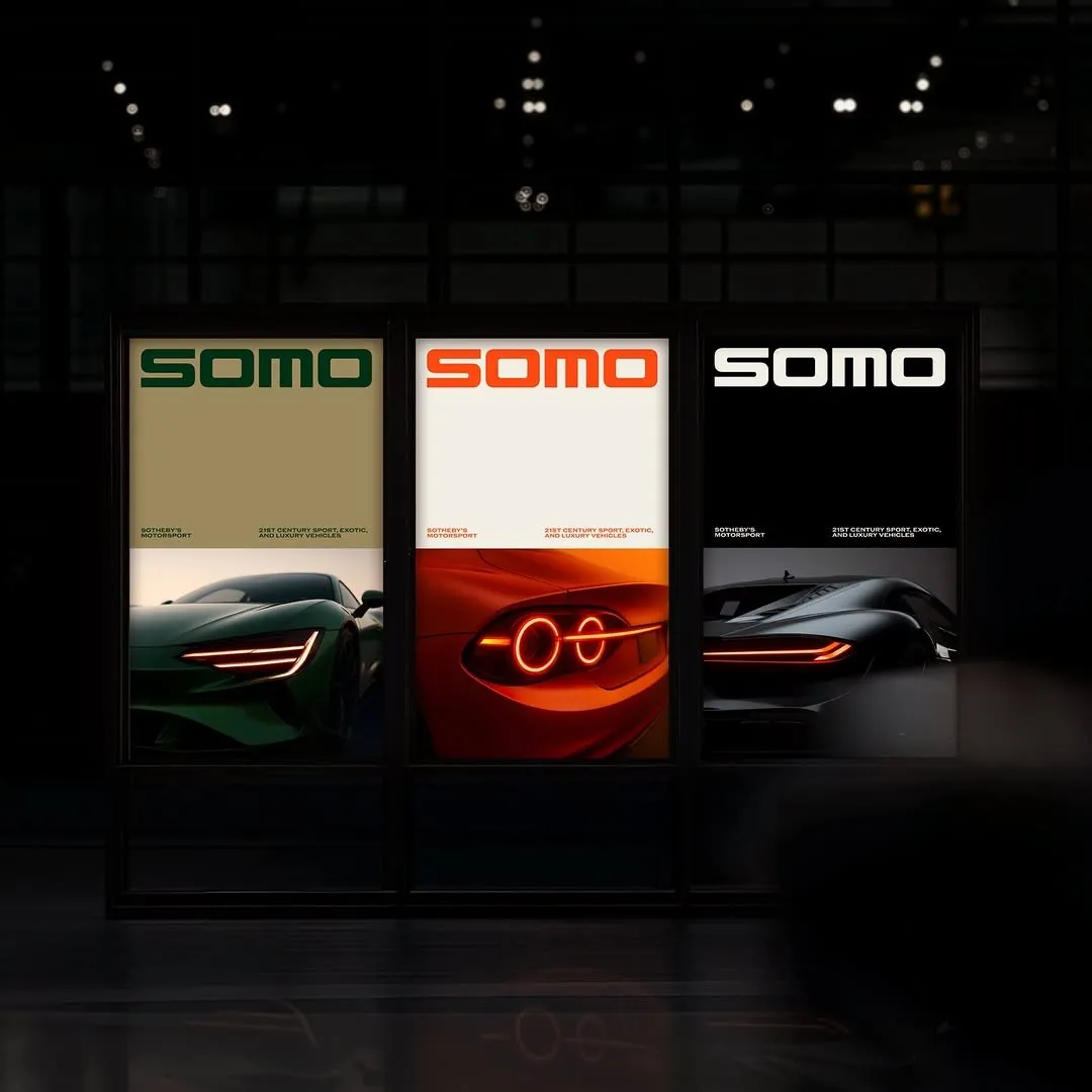 Three versions of the same poster in green, red and black hanging side by side in a dark room