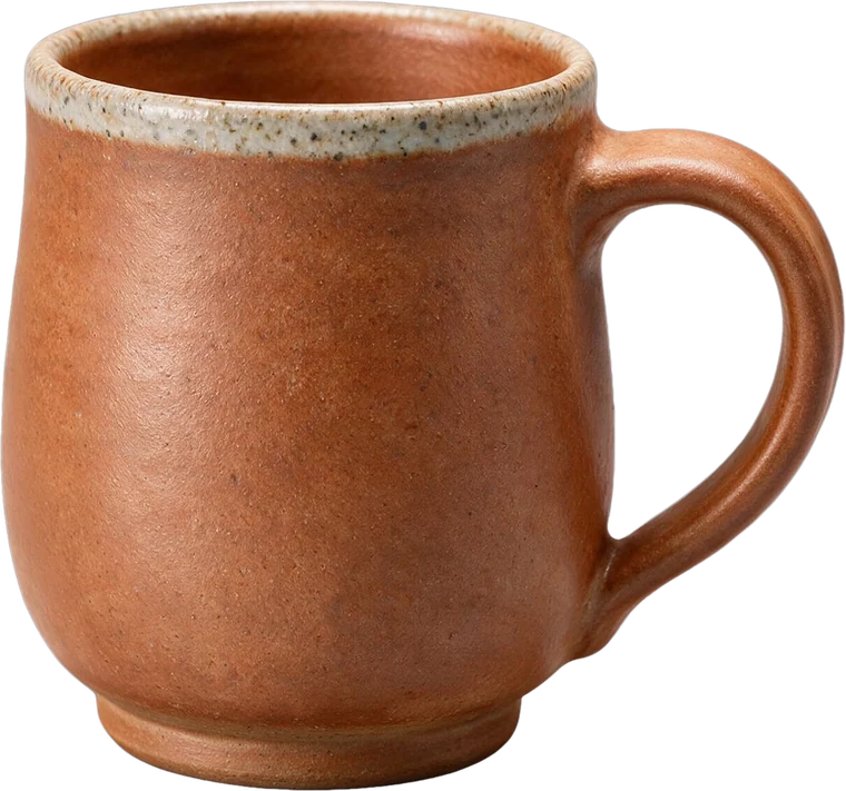 A handmade terracotta stoneware mug with a speckled rim