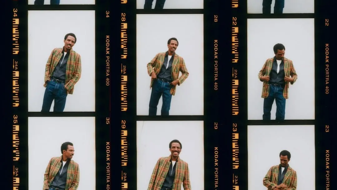 A film contact sheet of one model in a tan jacket, a dozen poses across two strips of Portra
